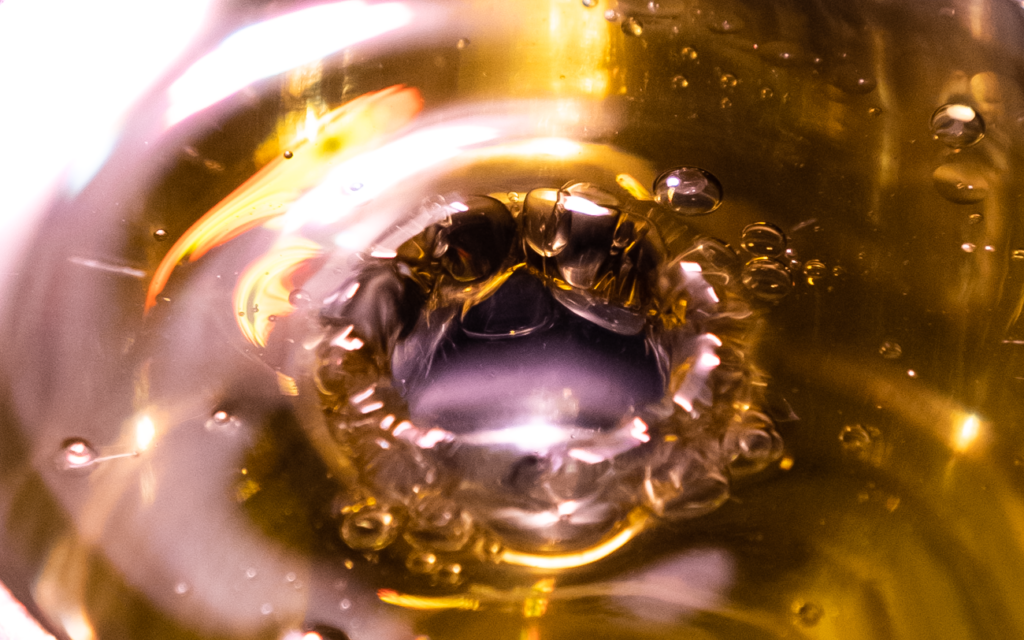 water droplets through olive oil.