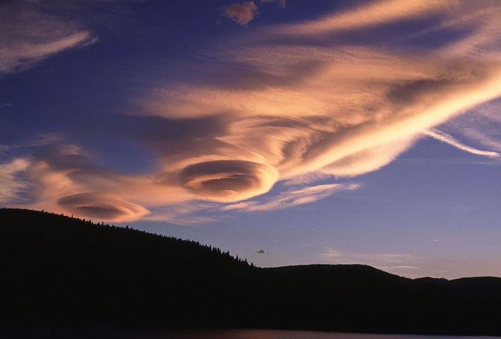 Lenticular Clouds at sunset over a mountain range